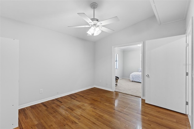 unfurnished bedroom with a ceiling fan, baseboards, and wood finished floors