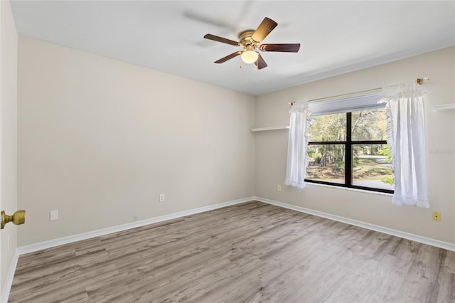 empty room featuring baseboards and wood finished floors