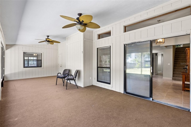 interior space featuring ceiling fan and vaulted ceiling