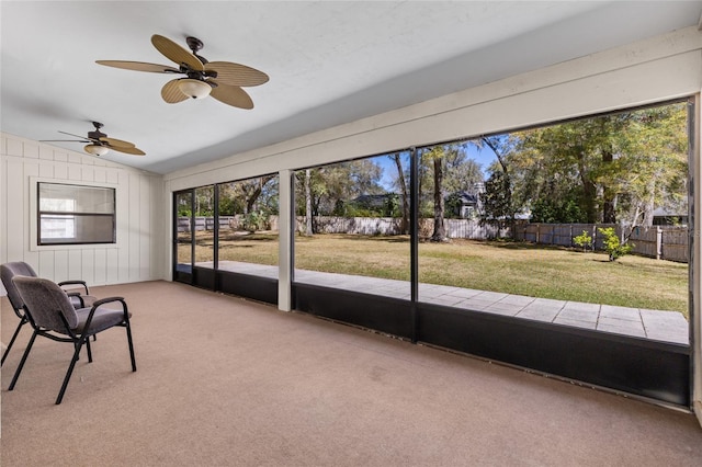 unfurnished sunroom with ceiling fan and vaulted ceiling