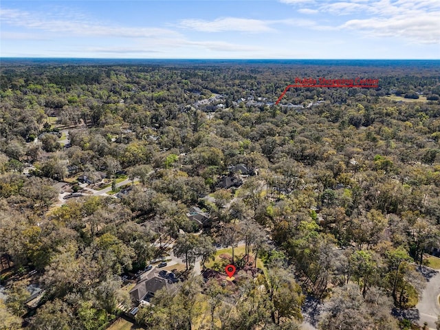 birds eye view of property with a wooded view