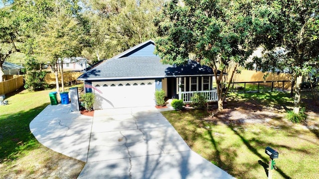 ranch-style home with an attached garage, concrete driveway, a front yard, and fence