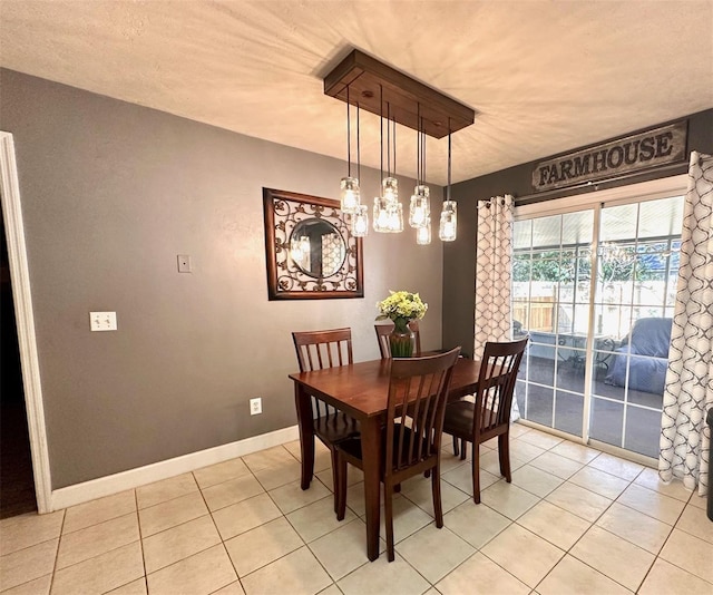 dining space with light tile patterned floors and baseboards