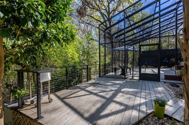 wooden terrace featuring glass enclosure