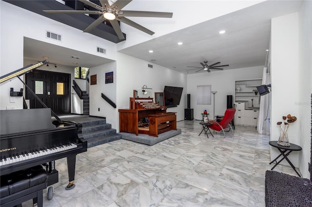 interior space with stairs, visible vents, marble finish floor, and ceiling fan