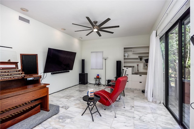 living area with visible vents, marble finish floor, and ceiling fan