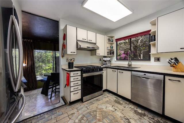 kitchen with open shelves, under cabinet range hood, stainless steel appliances, white cabinetry, and a sink