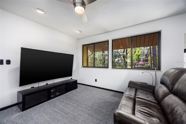 living area with carpet flooring, baseboards, and a ceiling fan