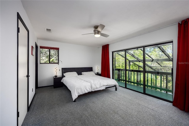 carpeted bedroom with access to exterior, visible vents, and ceiling fan