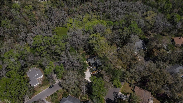 drone / aerial view with a wooded view