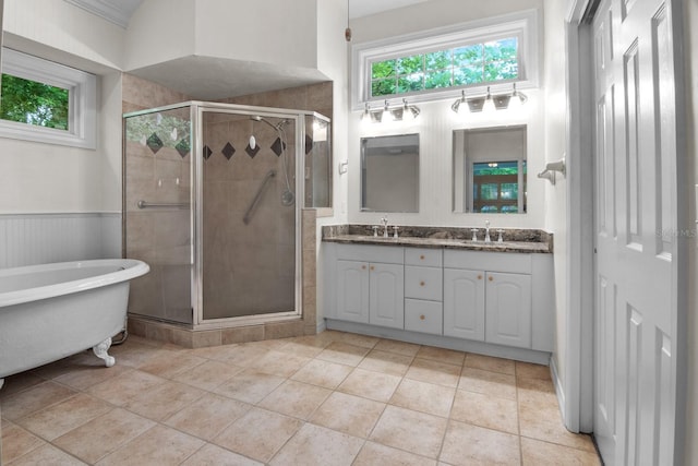 1132 SW 105th Ter, Gainesville, FL 32607 - bathroom featuring a stall shower, double vanity, a soaking tub, and wainscoting