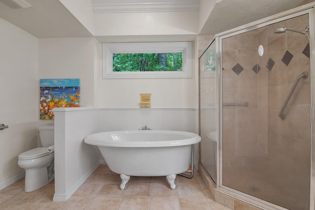 1132 SW 105th Ter, Gainesville, FL 32607 - full bath featuring toilet, a stall shower, tile patterned flooring, a freestanding tub, and a wainscoted wall