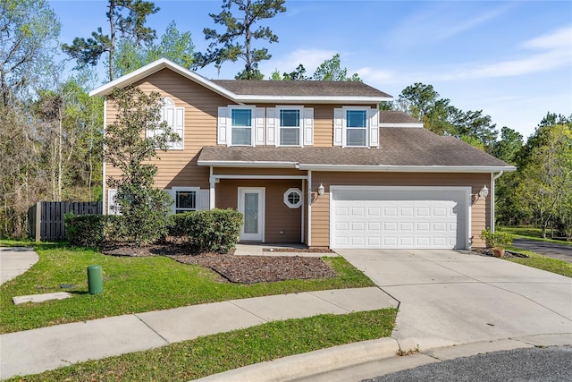 view of front facade featuring an attached garage, concrete driveway, a front lawn, and fence