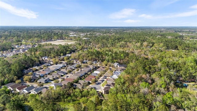 drone / aerial view featuring a residential view and a view of trees