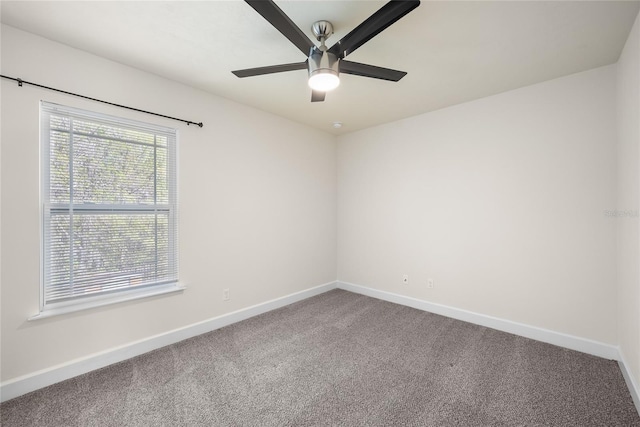 empty room with baseboards, a ceiling fan, and carpet floors