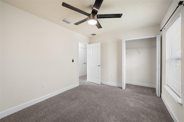 unfurnished bedroom with carpet, baseboards, visible vents, and a closet