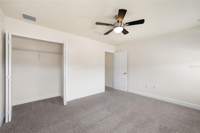 unfurnished bedroom with a closet, visible vents, baseboards, and carpet