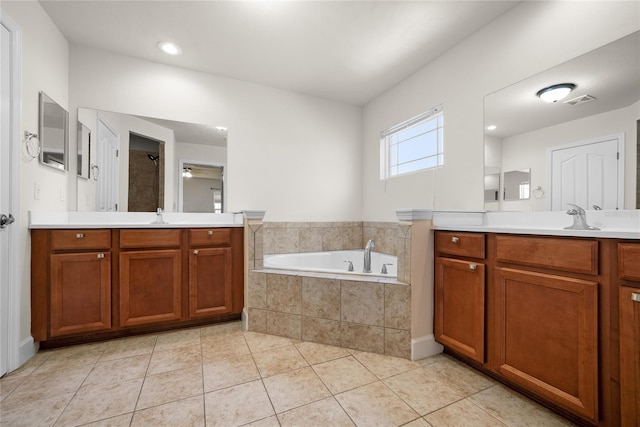 bathroom with visible vents, a garden tub, tile patterned floors, a ceiling fan, and a sink