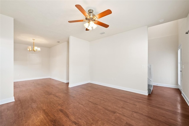 unfurnished room featuring visible vents, baseboards, wood finished floors, and ceiling fan with notable chandelier