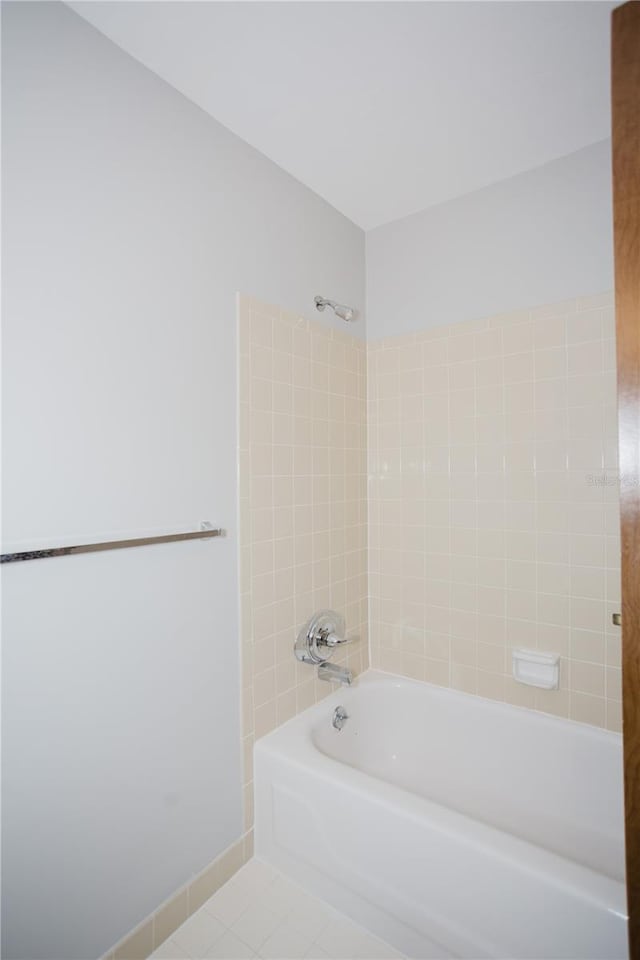 bathroom with tile patterned floors, baseboards, and bathtub / shower combination