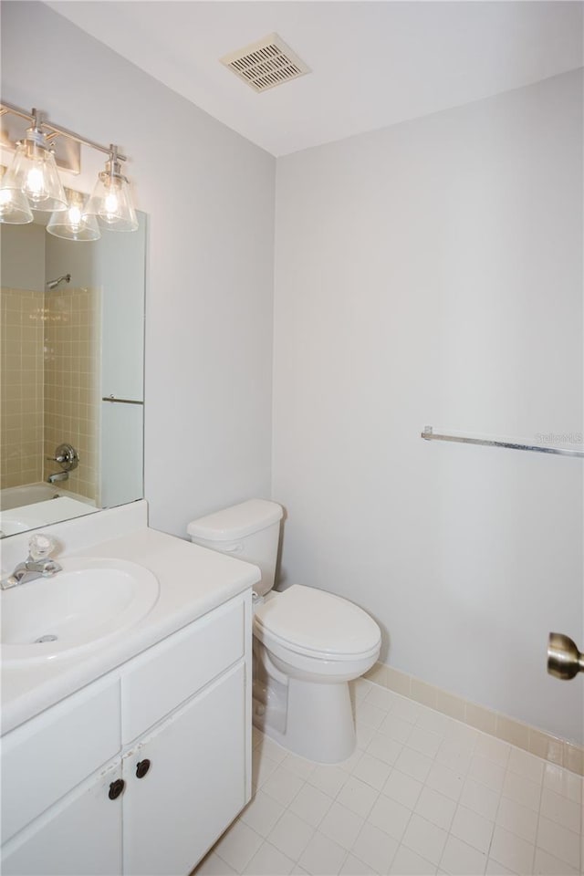 bathroom with vanity, visible vents, bathing tub / shower combination, tile patterned floors, and toilet