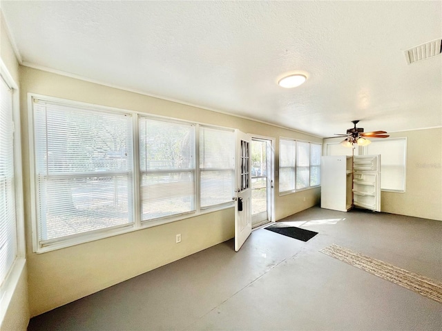 unfurnished sunroom with visible vents, french doors, and ceiling fan