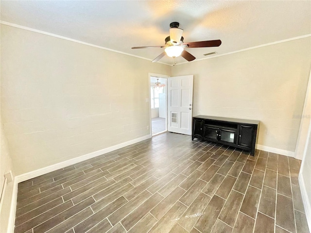 spare room featuring visible vents, dark wood-type flooring, a ceiling fan, and crown molding