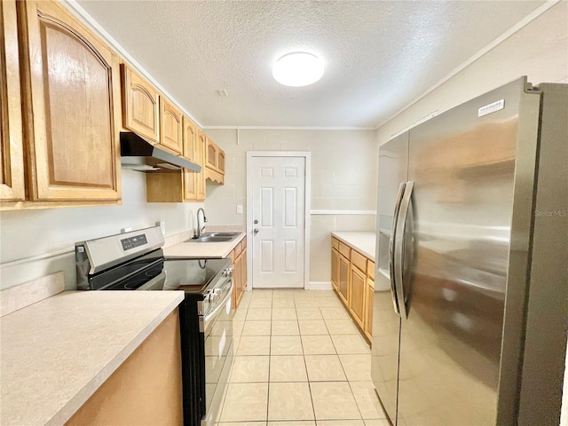 kitchen featuring light tile patterned flooring, a sink, stainless steel appliances, light countertops, and under cabinet range hood