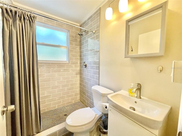 full bathroom with vanity, toilet, and tiled shower