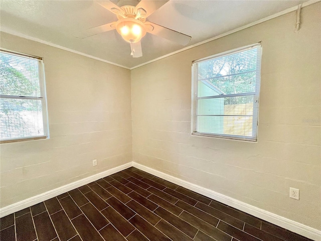 empty room with ceiling fan, baseboards, a healthy amount of sunlight, and ornamental molding