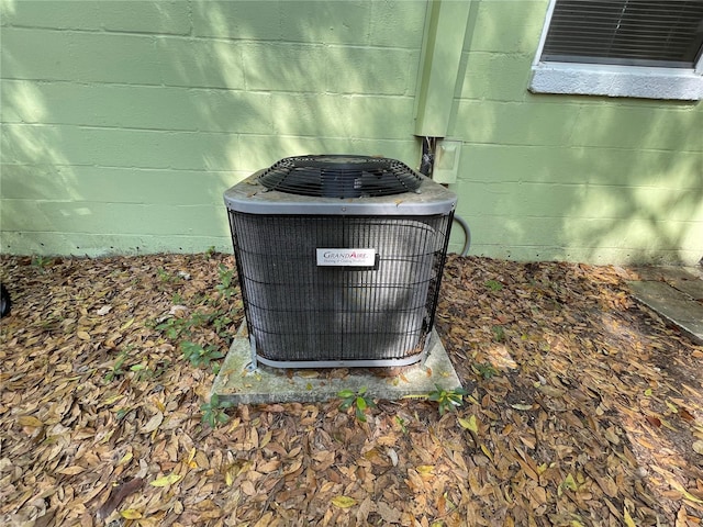 details featuring central AC unit and concrete block siding