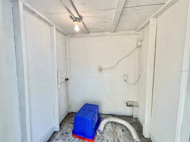 bathroom with concrete block wall