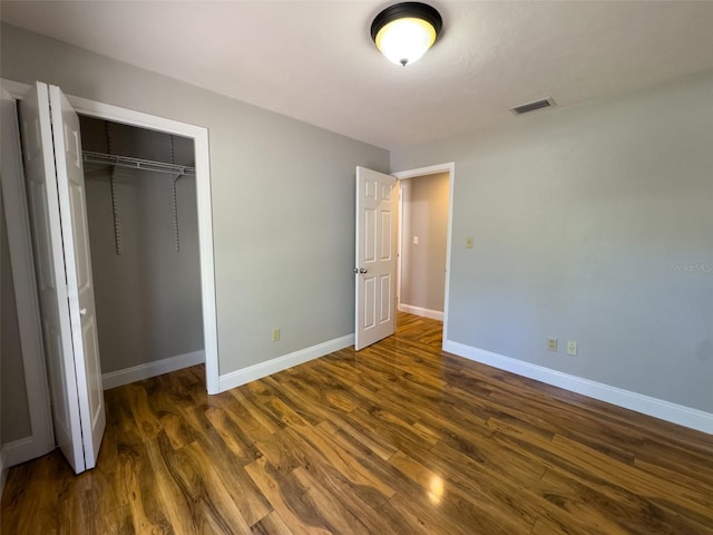 460 SE 4th Ave, Melrose, FL 32666 - unfurnished bedroom with visible vents, baseboards, a closet, and dark wood-style floors