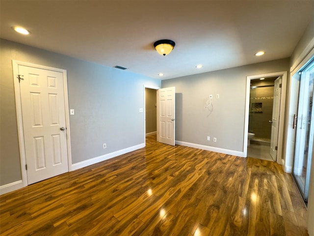 460 SE 4th Ave, Melrose, FL 32666 - unfurnished bedroom with baseboards, recessed lighting, ensuite bathroom, visible vents, and dark wood finished floors