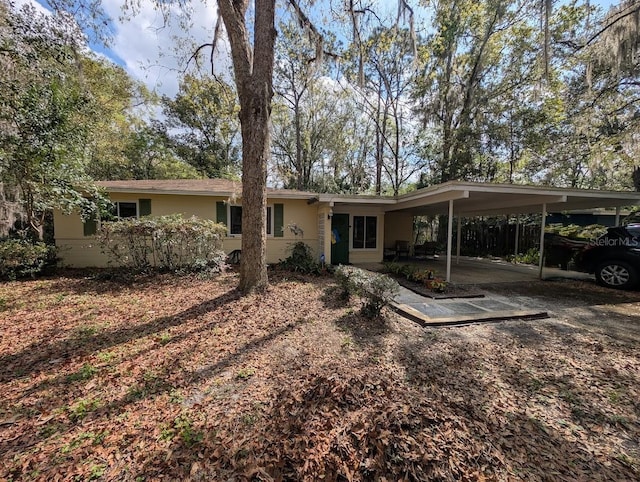 view of front of home with a carport and stucco siding