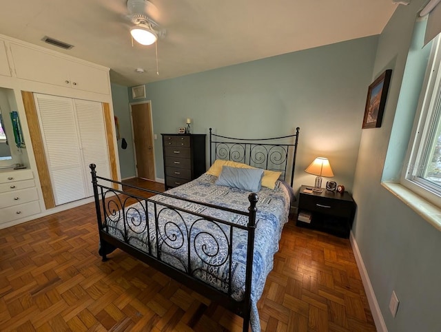 bedroom featuring visible vents, baseboards, a closet, and ceiling fan