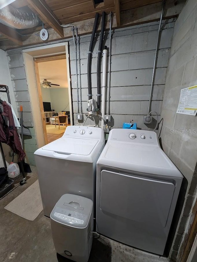 clothes washing area with laundry area and washer and clothes dryer