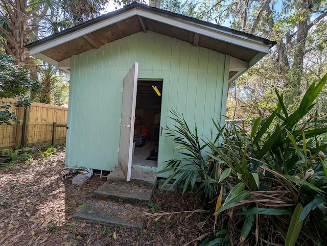 view of shed featuring fence