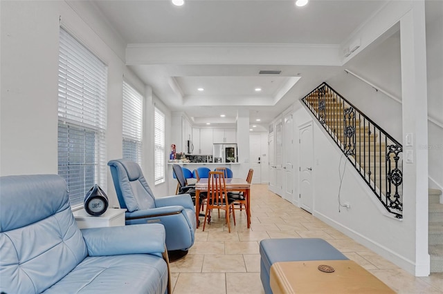 living area featuring stairs, a tray ceiling, recessed lighting, and visible vents