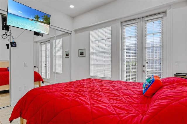 bedroom featuring tile patterned floors, multiple windows, french doors, and access to exterior