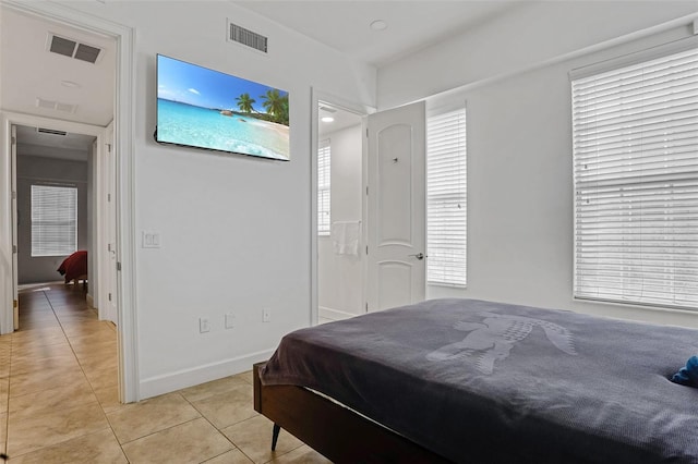 bedroom with visible vents, baseboards, and light tile patterned flooring