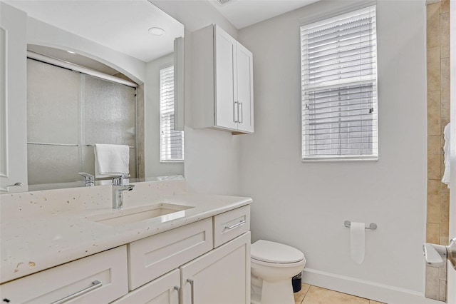 full bath with vanity, baseboards, tile patterned flooring, an enclosed shower, and toilet