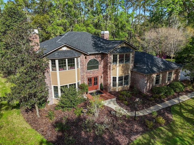 1118 SW 112th St, Gainesville, FL 32607 - raised ranch with a front lawn, brick siding, a chimney, and a shingled roof