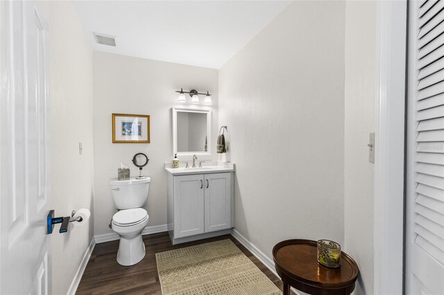 1118 SW 112th St, Gainesville, FL 32607 - half bath with baseboards, toilet, wood finished floors, and vanity