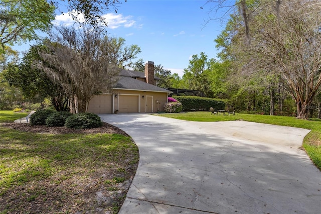 1118 SW 112th St, Gainesville, FL 32607 - exterior space featuring a front lawn, an attached garage, driveway, and a chimney
