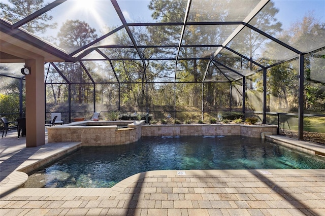 view of pool with a lanai, a pool with connected hot tub, and a patio