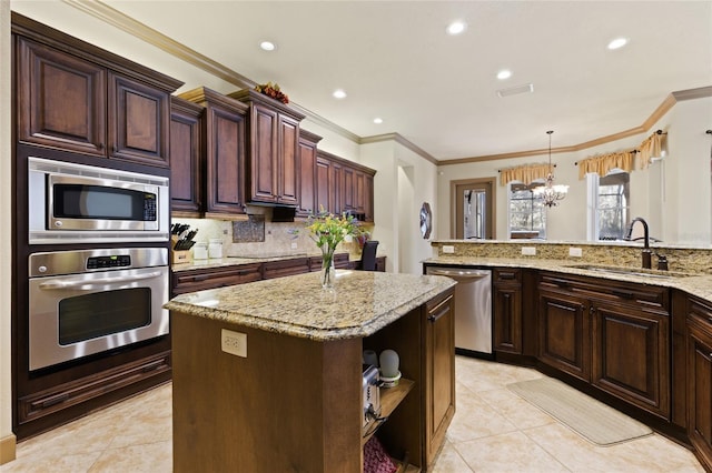 kitchen with tasteful backsplash, a sink, a chandelier, appliances with stainless steel finishes, and open shelves