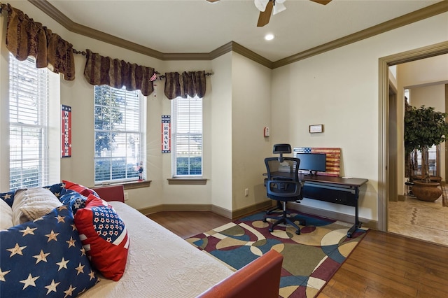 bedroom featuring baseboards, hardwood / wood-style floors, and crown molding