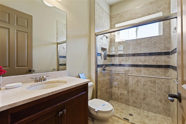 full bathroom with vanity, toilet, and a shower stall