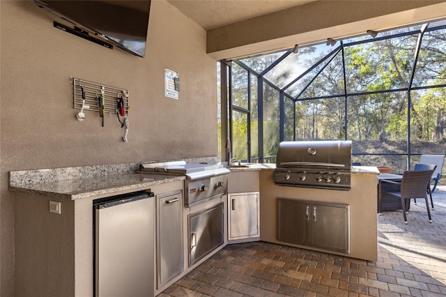 view of patio / terrace featuring grilling area, area for grilling, and glass enclosure